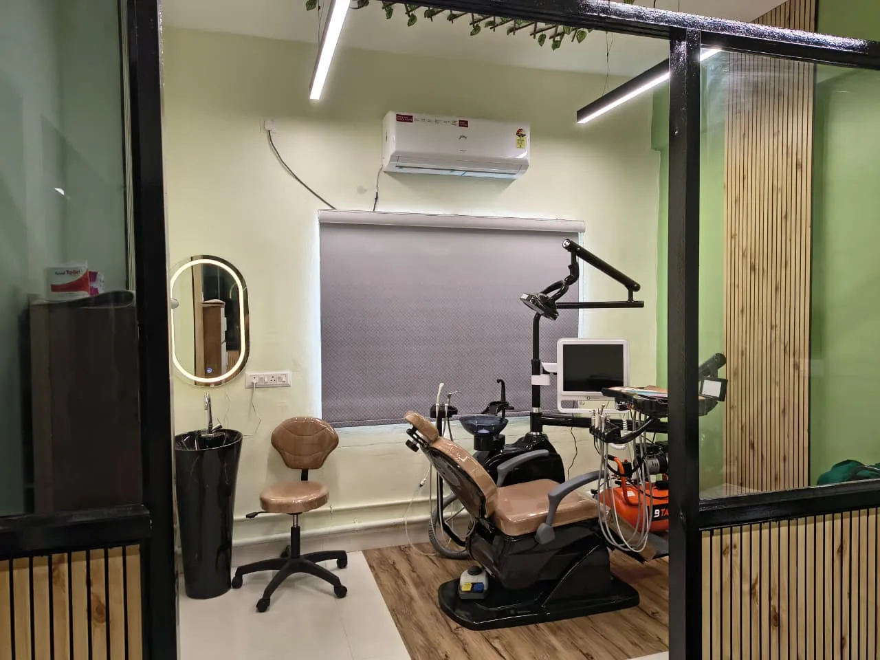 Treatment room with the dental chair, overhead light and monitor